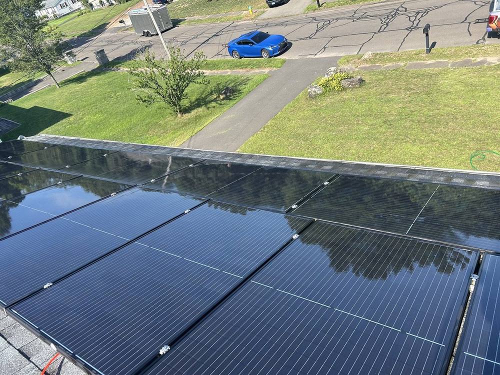 Clean solar array reflecting blue sky after a Sullivan Solar Services cleaning